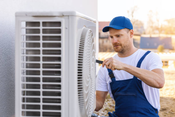 HVAC technician servicing an outdoor air conditioner in Clovis